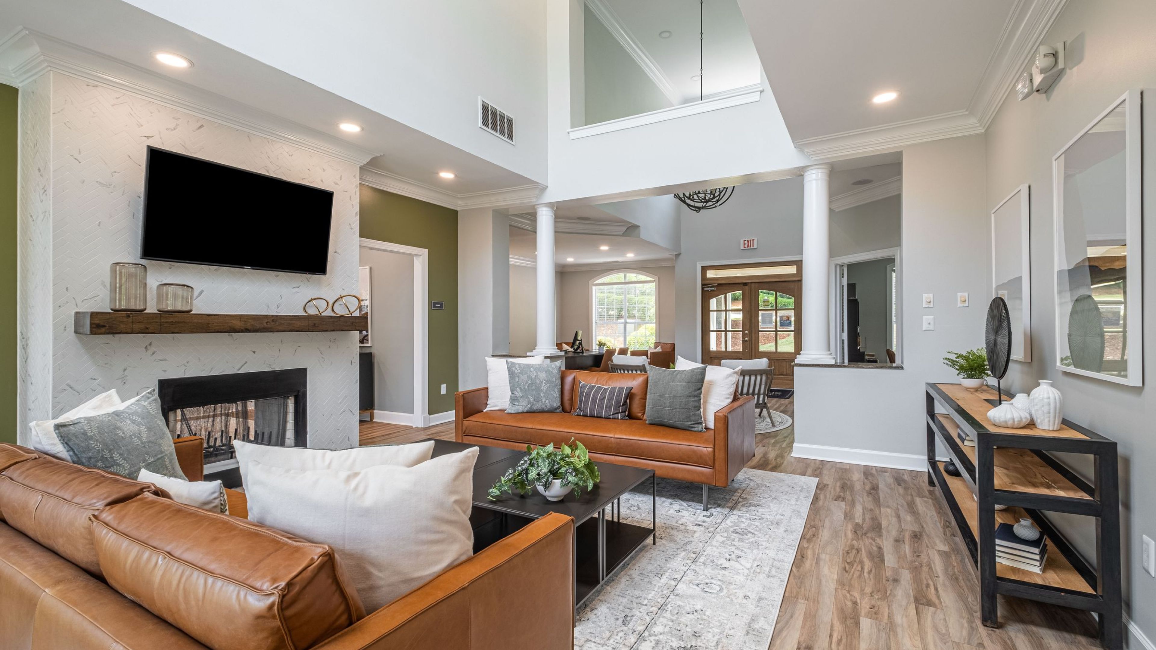 Hawthorne at Lake Heather resident clubhouse lounge area with couches and a TV.