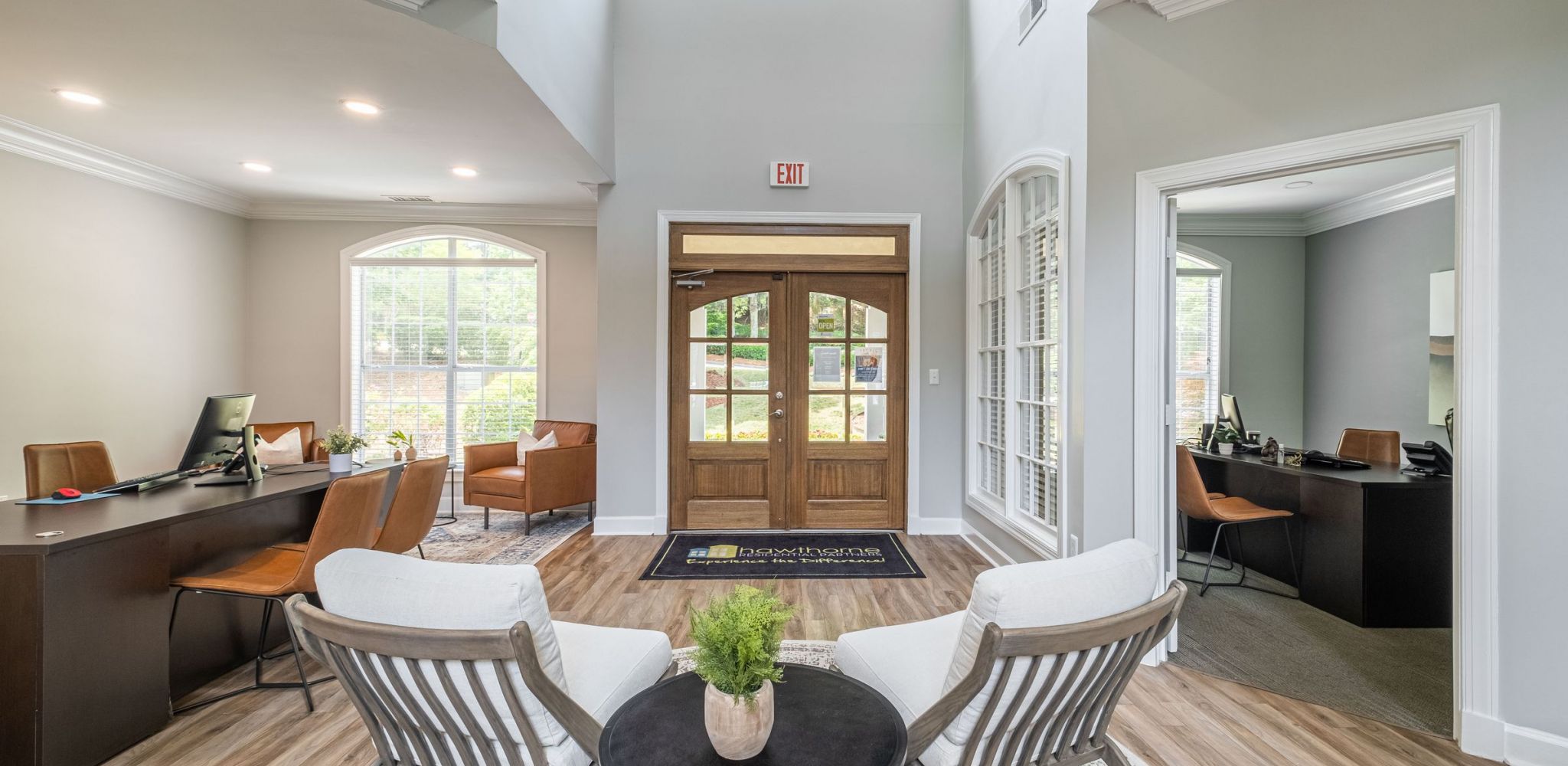 Hawthorne at Lake Heather entrance to resident clubhouse with a welcome desk and ample seating for guests.